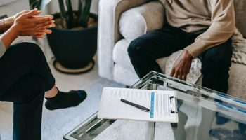 two people sitting opposite of each other in a counseling session